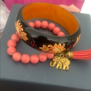 Black bangle and orange bracelet